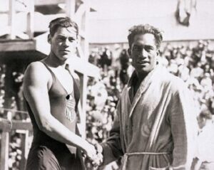 The 1924 Olympic swimmers in France. Duke Kahanamoku and Johnny Weismuller, shaking hands.