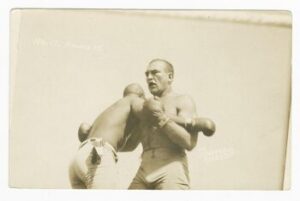 postcard of Jack Johnson and James J. Jeffries clinching from the Dana Photo Studio, American.
