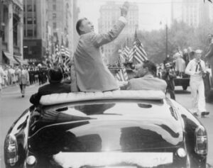 Ben Hogan seated on the back of a car in the homecoming parade on Broadway