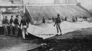 This shows the Steelers’ players pulling off the tarp prior to practice before the game later that week with the Eagles on 12/21/47. Photo credit would be for the Pittsburgh Sun-Telegraph.
