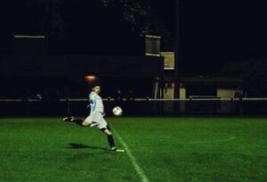 Player kicking soccer ball