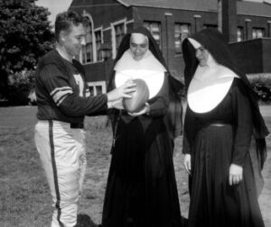 Jim Finks with nuns. Sourced via Jim Finks Foundation website.