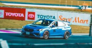 Blue Subaru racing on the track.