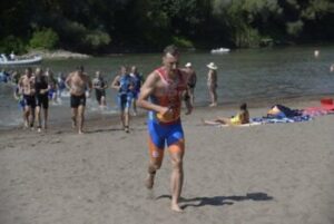 Triathlete transitioning from swim to bike at a triathlon event
